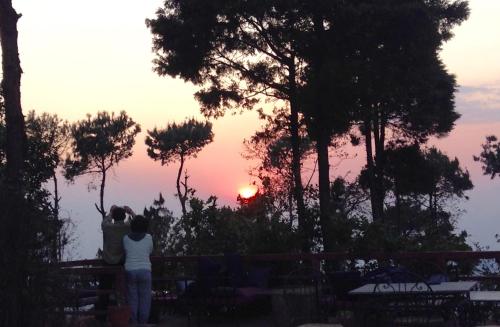 a group of people looking at the sunset at Hotel At The End Of The Universe in Nagarkot