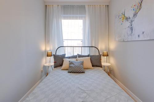 Un pat sau paturi într-o cameră la Apartamenty Chmielna 72