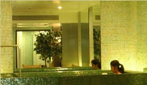two people sitting at a counter in a bathroom at The Imperial Palace in Rajkot