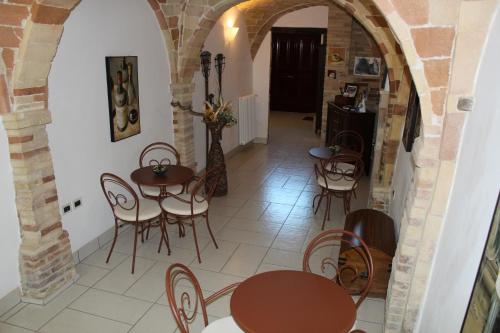 a hallway with tables and chairs in a building at La Casa Del Palombaro in Ortona
