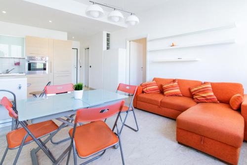 a living room with a couch and a table at Orange Apartment Bologna in Bologna