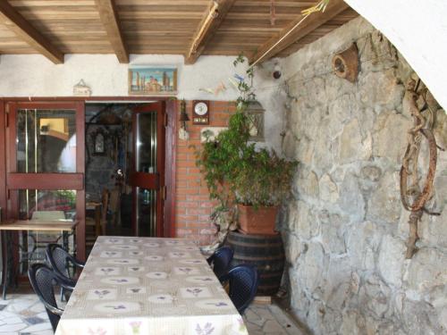 a table and chairs in a room with a stone wall at Apartment Vesna Opatija free parking in Opatija