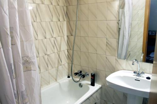 a bathroom with a tub and a sink and a shower at Apartamentos Paradis Blanc 3000 in Pas de la Casa