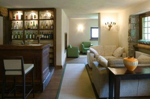 a living room with a couch and a bar at Maison Tissiere in Antey-Saint-André