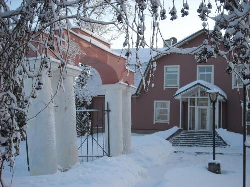 a red house with snow on the ground at Birinu Pils in Bīriņi