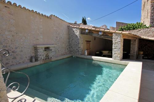 a swimming pool in front of a house at Ancienne Cure in Buis-les-Baronnies