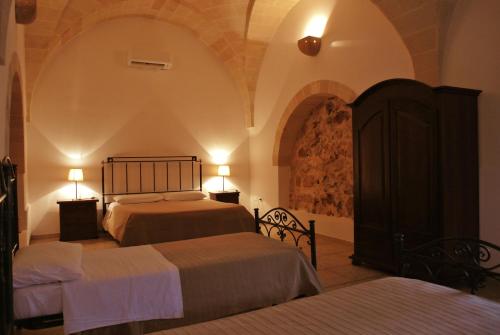 Un pat sau paturi într-o cameră la Masseria Nuova