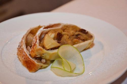 a white plate with a pie with apples on it at Maison Tissiere in Antey-Saint-André