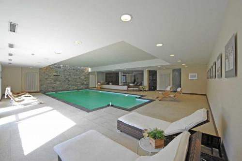 a large living room with a swimming pool at Maison Tissiere in Antey-Saint-André