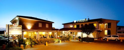 a group of buildings with cars parked in a parking lot at Hotel La Campagnola in Fucecchio