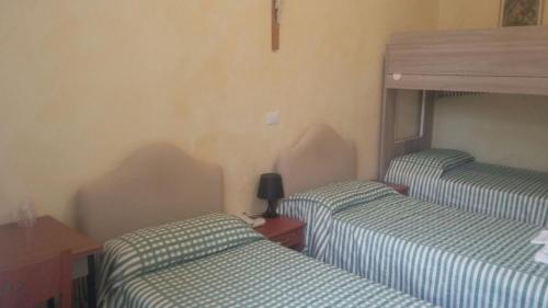 a room with two twin beds in a room at Ostello Villa Monte Mario in Rome
