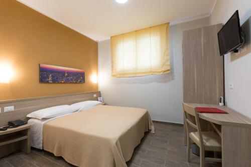 a hotel room with a bed and a television at Hotel La Campagnola in Fucecchio