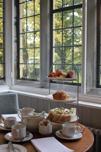 a table with plates of food and cups and cakes at Mallyan Spout Hotel in Goathland