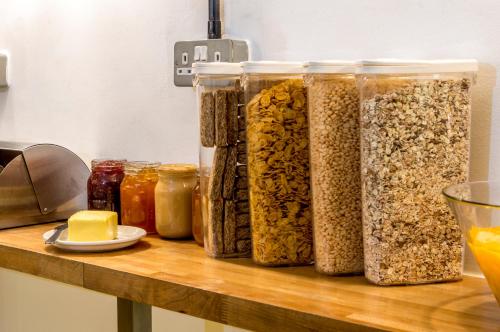 a counter with jars of oatmeal and other food items at Safestay Madrid Central in Madrid