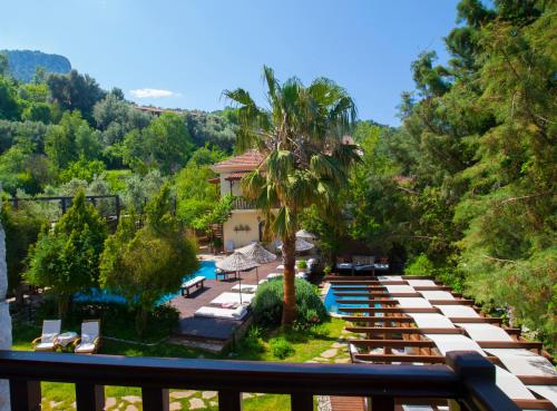 a view of a resort with a pool and trees at Mandarin & Mango Boutique Hotel in Faralya