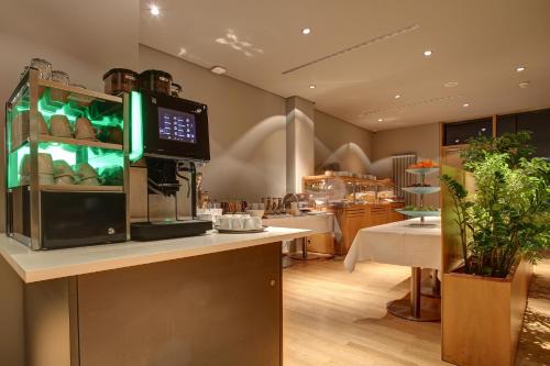 a restaurant with a kitchen with aasteryasteryasteryasteryasteryasteryasteryasteryastery at Centro Park Hotel Stuttgart, Trademark Collection by Wyndham in Ostfildern