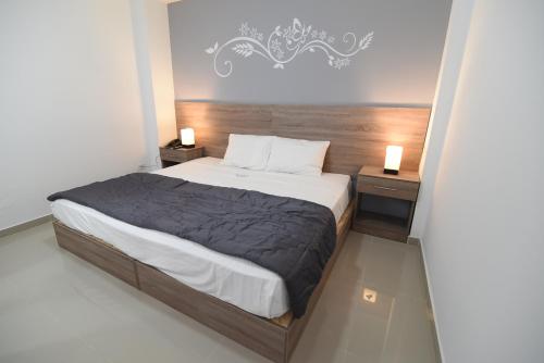 a bedroom with a large bed with two night stands at Escala Urban Hotel in Chiclayo