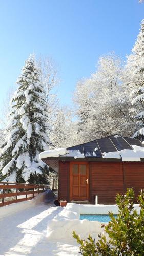 a cabin with a solar roof in the snow at Svycarska Bouda in Špindlerův Mlýn