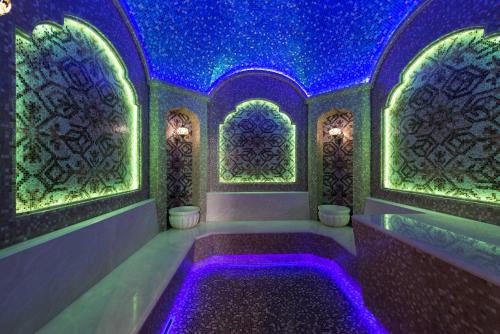 a room with a bath tub with purple lights at Riviera Zoloche Resort & Spa in Vishenki