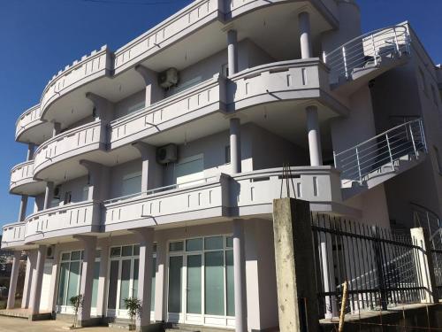 a white building with balconies on the side of it at Apartments Flamida in Ulcinj
