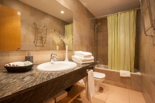 a bathroom with a sink and a toilet at Rosselló Apartment in Barcelona