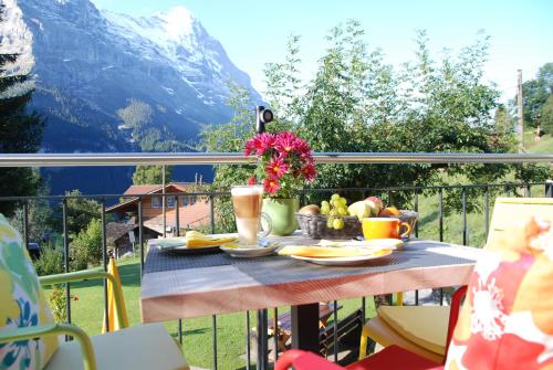 a table topped with plates of food and drinks at Hotel Lauberhorn - Home for Outdoor Activities in Grindelwald
