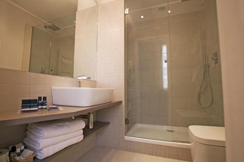 a bathroom with a sink and a shower at Hotel Savoia in Alassio