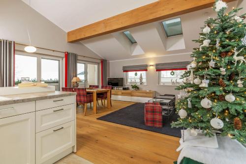a kitchen and living room with a christmas tree at Haus Bella Vista in Reit im Winkl