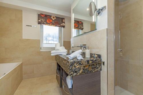 a bathroom with a sink and a mirror at Haus Bella Vista in Reit im Winkl