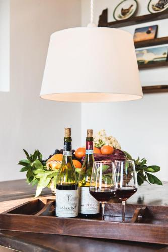 two bottles of wine on a table with a lamp at Corte San Mattia in Verona