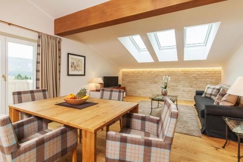a living room with a wooden table and chairs at Haus Bella Vista in Reit im Winkl