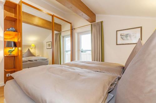 a bedroom with a bed and a large mirror at Haus Bella Vista in Reit im Winkl