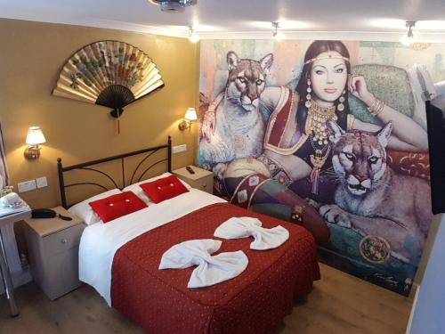 a bedroom with a bed with a painting on the wall at Central Hotel in London