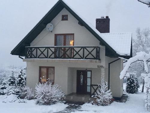 a white house with snow on the ground at Studio Nina in Raba Wyżna