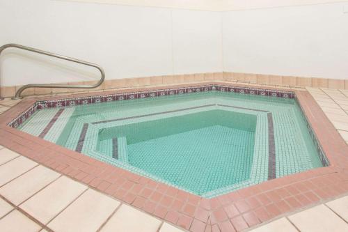 a swimming pool in a room with a tile floor at Travelodge by Wyndham Williams Grand Canyon in Williams