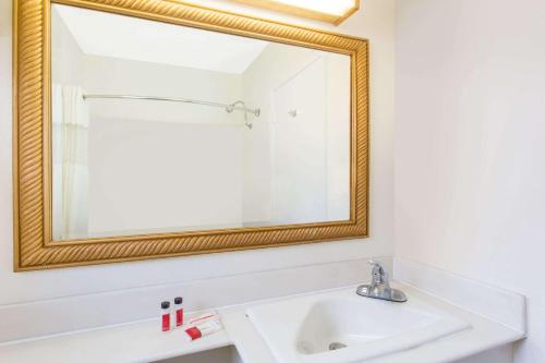 a bathroom with a white sink and a mirror at Travelodge by Wyndham Williams Grand Canyon in Williams