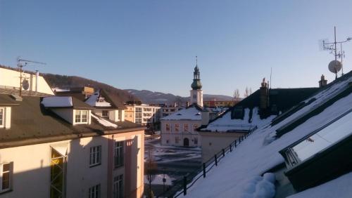 a view of a city with snow covered roofs at Jeseník náměstí podkroví in Jeseník