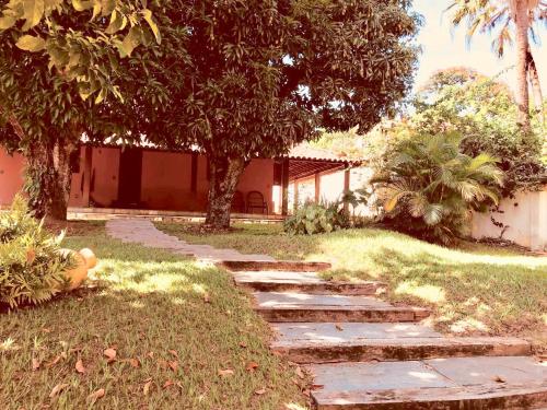 a garden with a stone path in front of a house at Margem da Lagoa Santa in Lagoa Santa