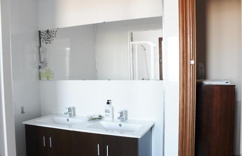 a bathroom with a white sink and a mirror at Casas Medina Güevéjar in Güevéjar