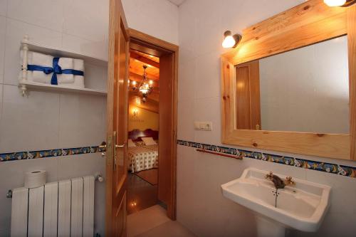 a bathroom with a sink and a mirror at Casa Mariñeira Lourdes in Cambados