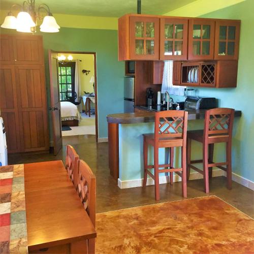 a kitchen with a table and chairs in a room at Royale Manor in Corozal