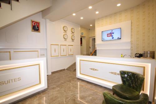 a waiting room with a chair and paintings on the wall at Vita Suites Karaköy in Istanbul