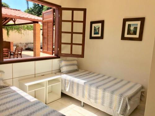 מיטה או מיטות בחדר ב-Margem da Lagoa Santa