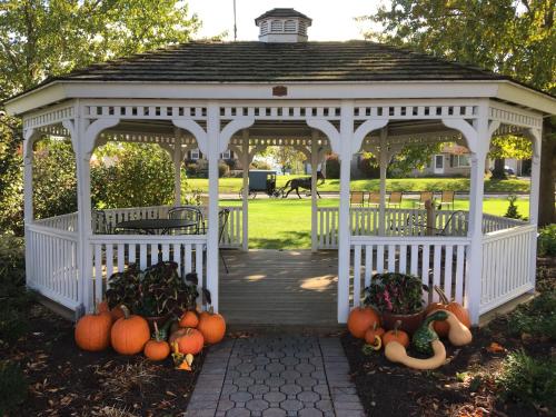 a white gazebo with pumpkins on the ground at Travelers Rest Motel in Intercourse