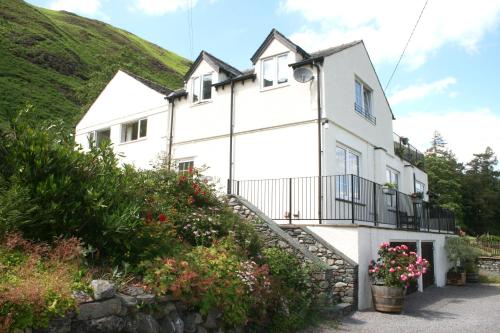 a white house with a hill in the background at StoneyFell in Keswick