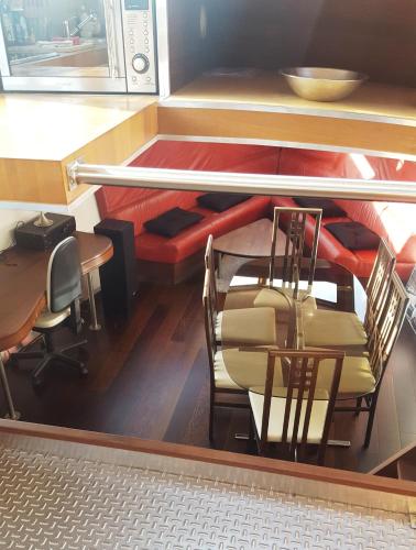 a room with a table and chairs and a couch at Le Bateau Ivre in Bordeaux