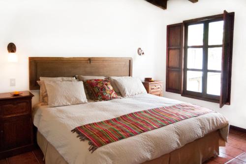 a bedroom with a large bed and a window at Villas Santa Ana in Antigua Guatemala