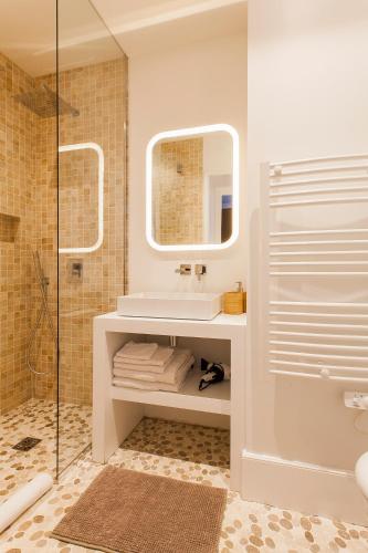 une salle de bain avec un lavabo et une douche dans l'établissement Maison TANDEM, à Cluny