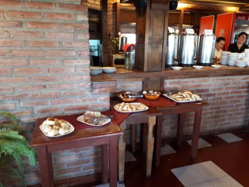 two tables with food on them in a restaurant at Villa de Merlo All Inclusive & Spa by MH in Merlo