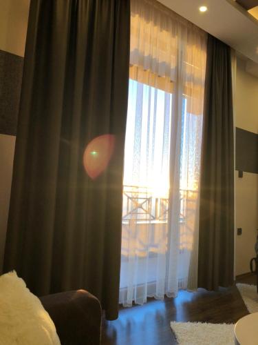 a room with a window with the sun shining through at Silver Mountain Milmari in Kopaonik